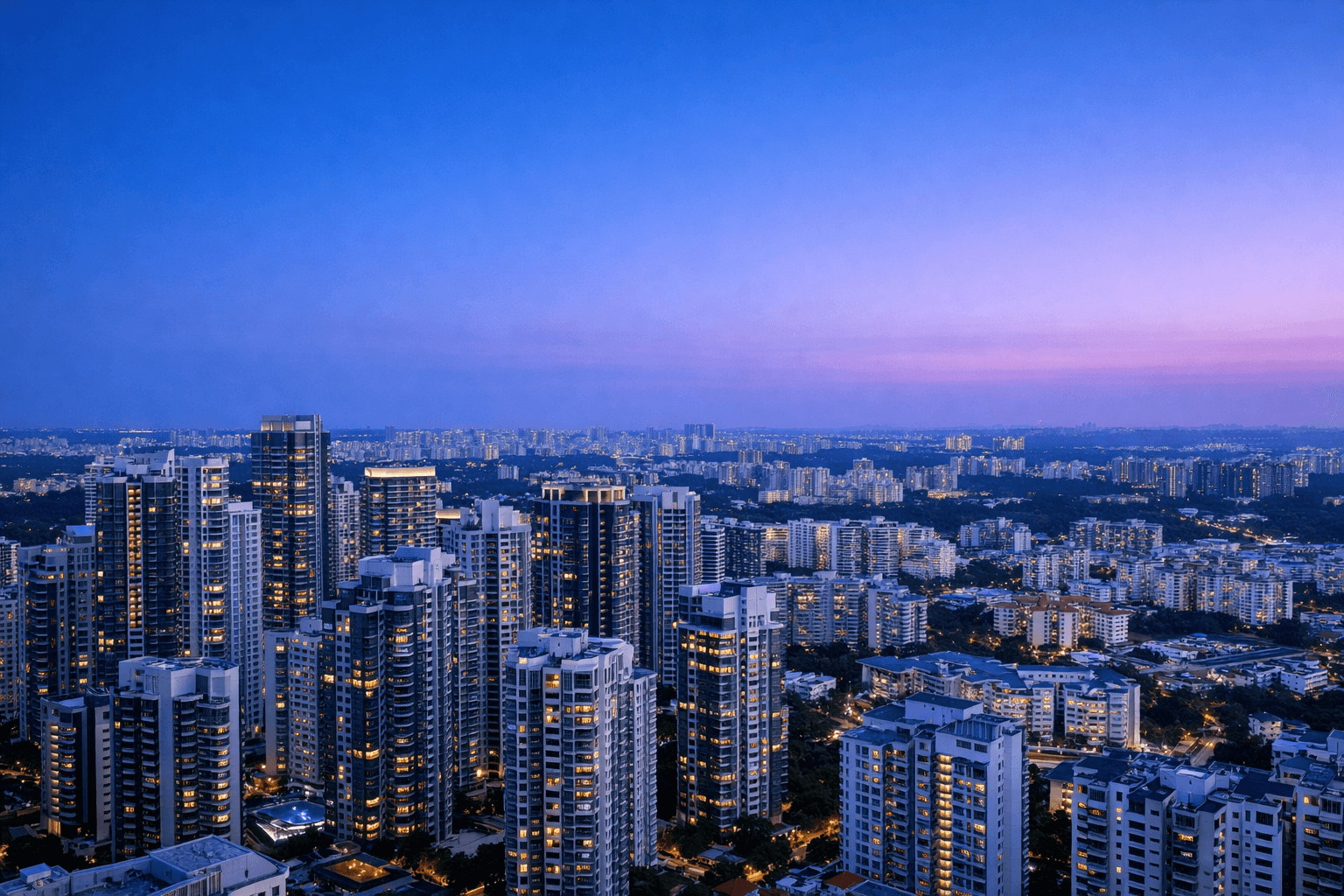 An elevated view of Singapore from central high-rises to suburban estates at dusk.