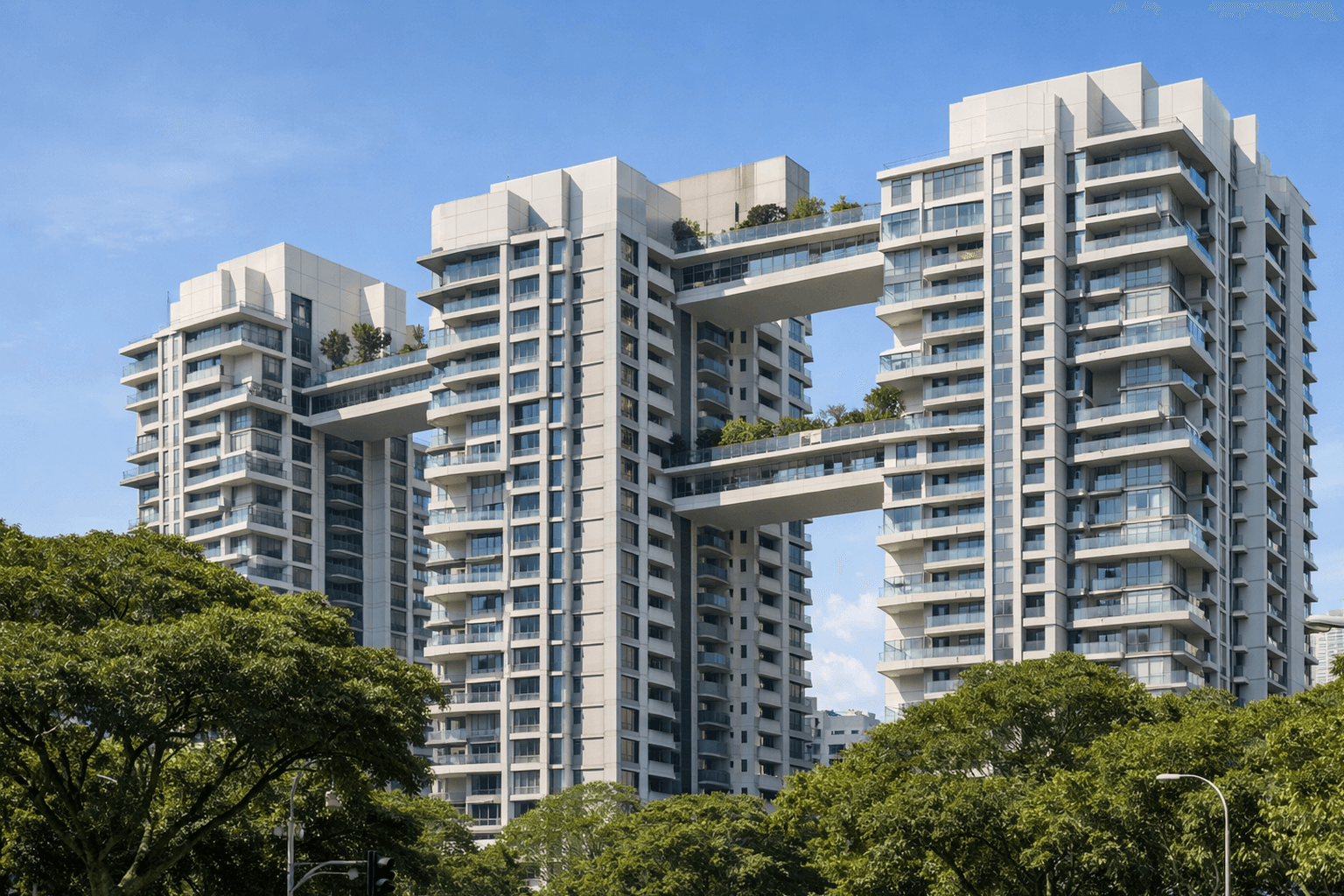 Modern high-rise public housing blocks with sky terraces rising above trees in Singapore.