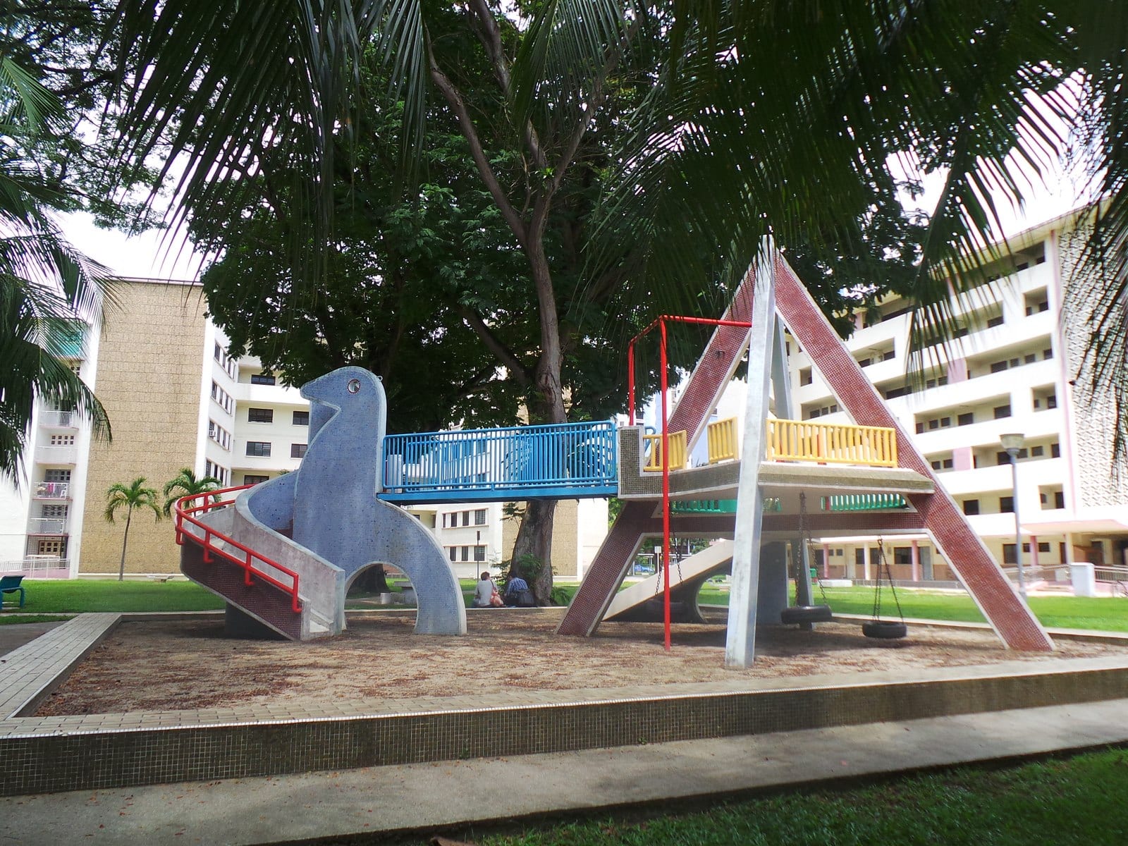 The heritage Dove mosaic playground at Dakota Crescent, ringed by the old District 15 HDB flats off Old Airport Road — the mature Dakota/Katong precinct around Grand Dunman.