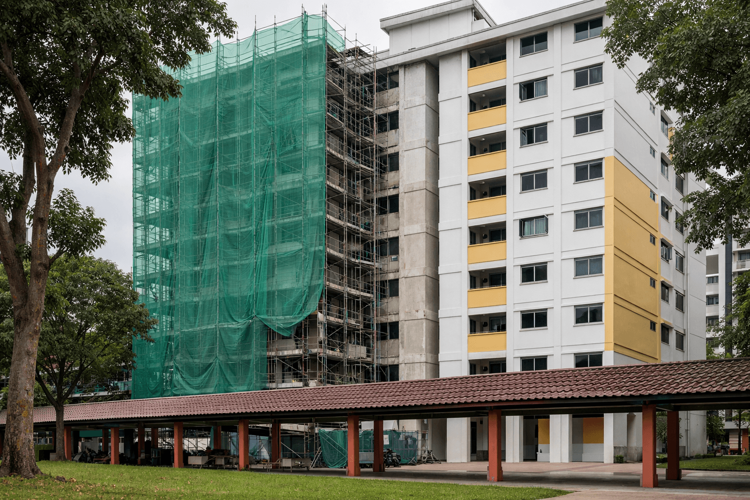 An older HDB block with scaffolding and fresh paint during upgrading works.