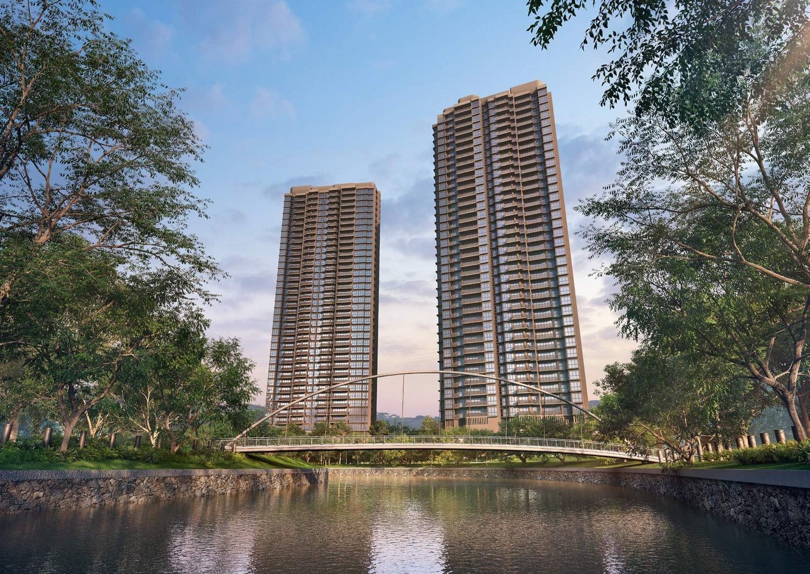 Twin residential towers rising above the Singapore River at River Valley in District 9 at dusk, with a landscaped riverside promenade in the foreground and the city skyline behind.