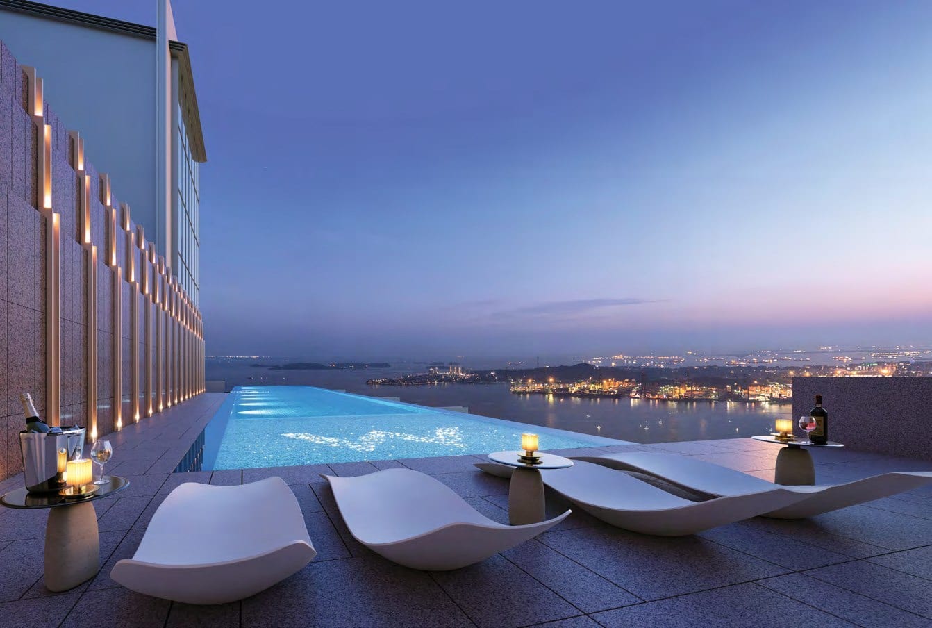 Infinity pool deck at W Residences Marina View overlooking the Marina Bay and Downtown Core skyline at dusk.